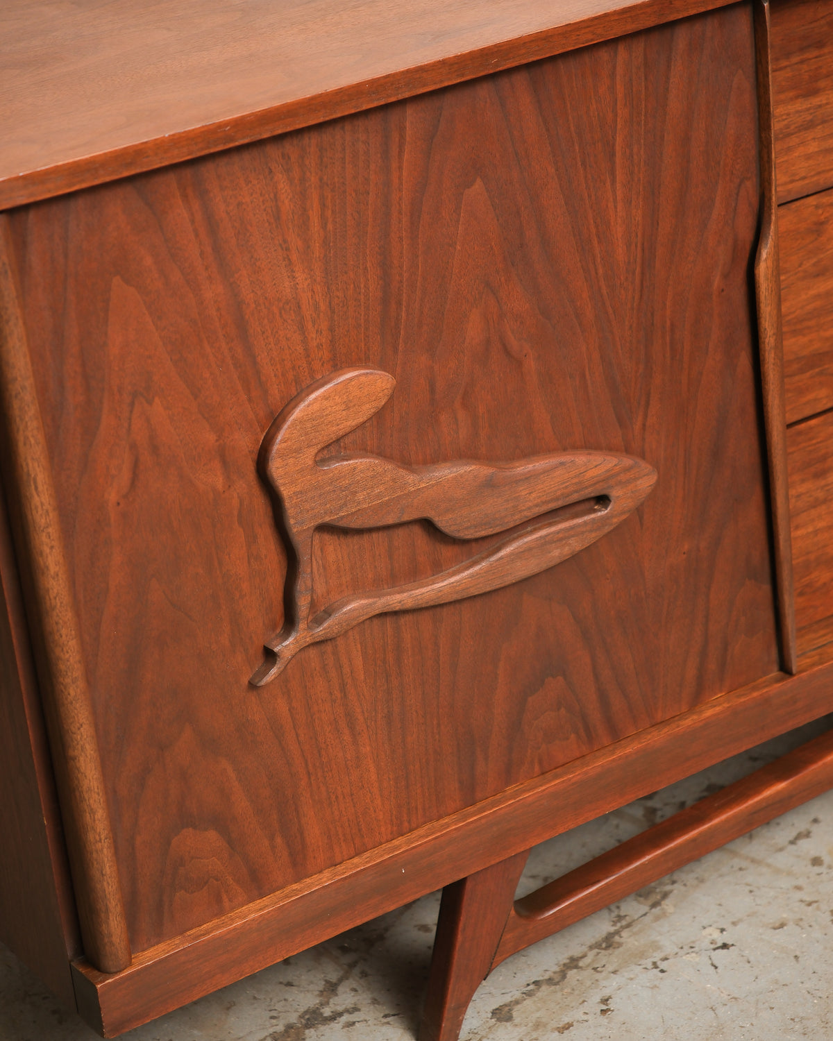 Side angle of the sideboard highlighting the case depth and leg construction