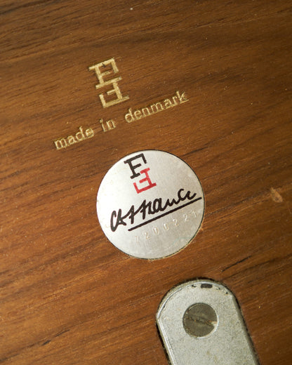 Close-up of the Cado maker's mark and 'Made in Denmark' stamp with signature and serial number on teak.