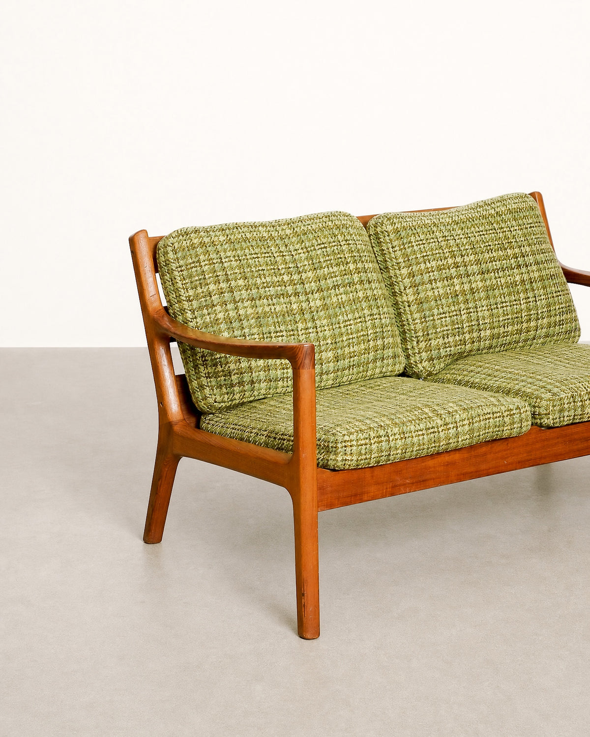 Side profile of the sofa showing the frame silhouette and leg taper.