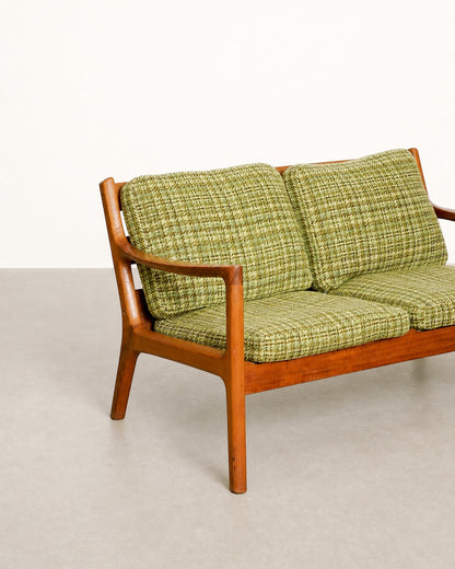 Side profile of the sofa showing the frame silhouette and leg taper.