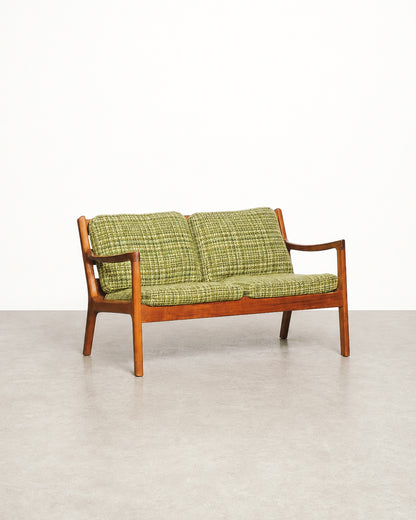 Close-up of the back cushion corner showing upholstery weave and piping.