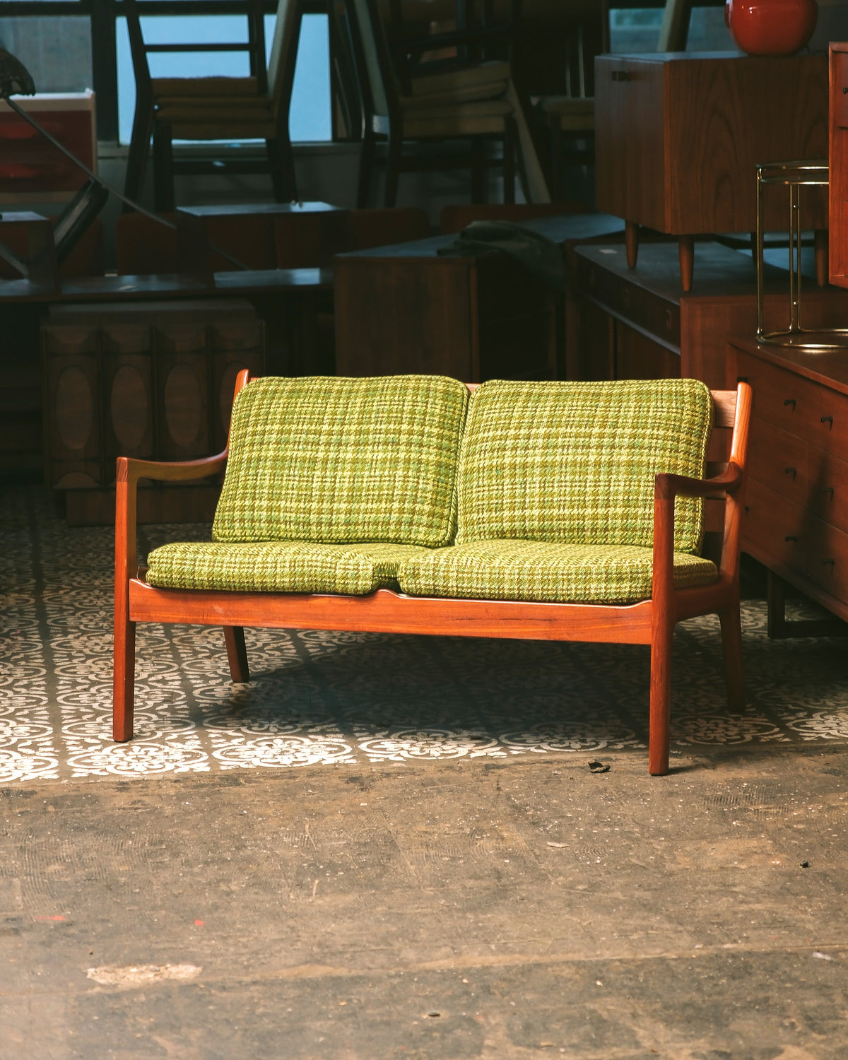 Full view of the Ole Wanscher teak 'Senator' sofa in a showroom setting.