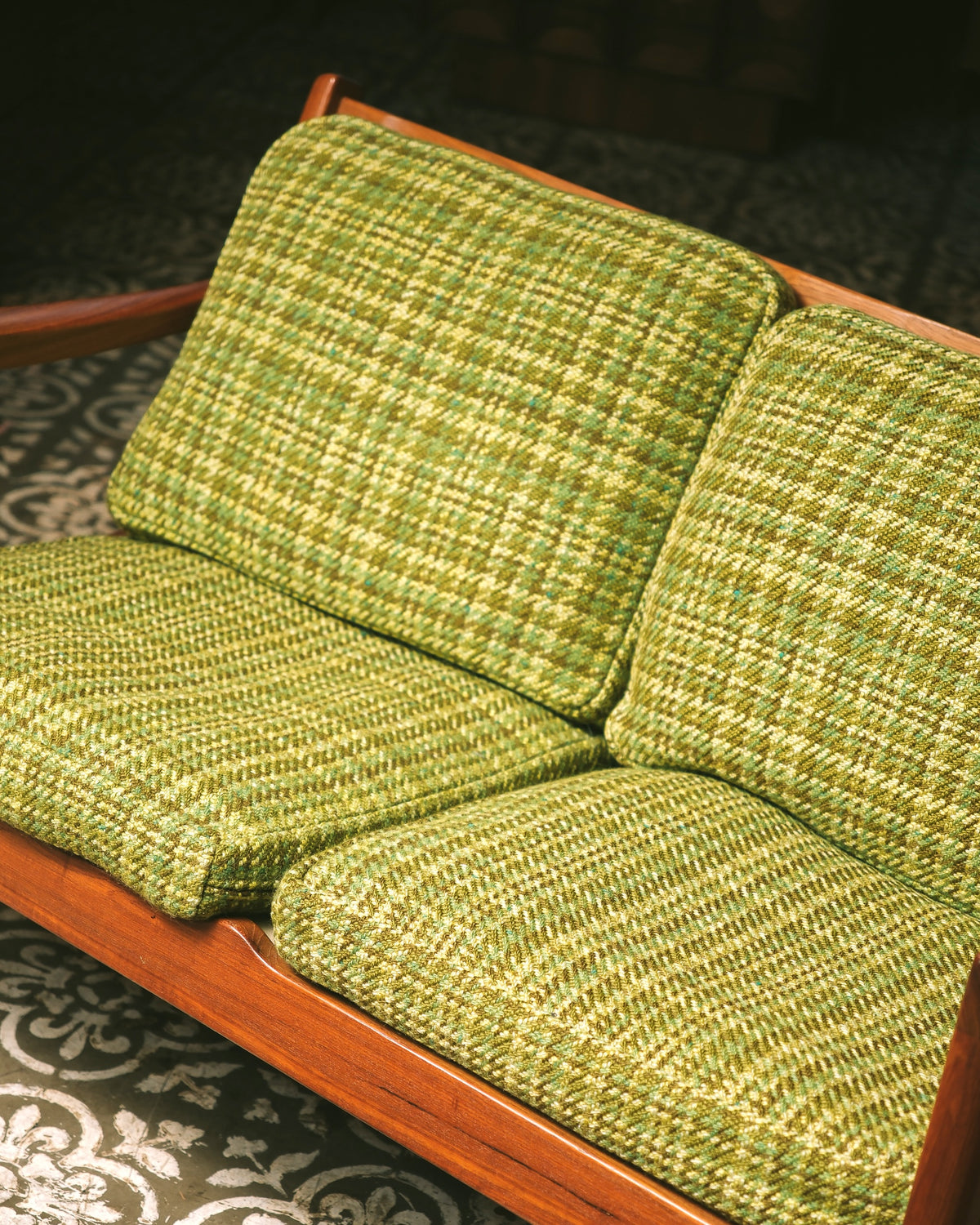 Overhead angle of the seat and back cushions showing the plaid upholstery pattern.