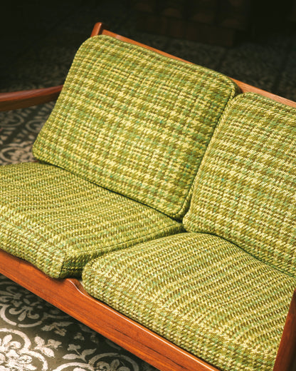 Overhead angle of the seat and back cushions showing the plaid upholstery pattern.