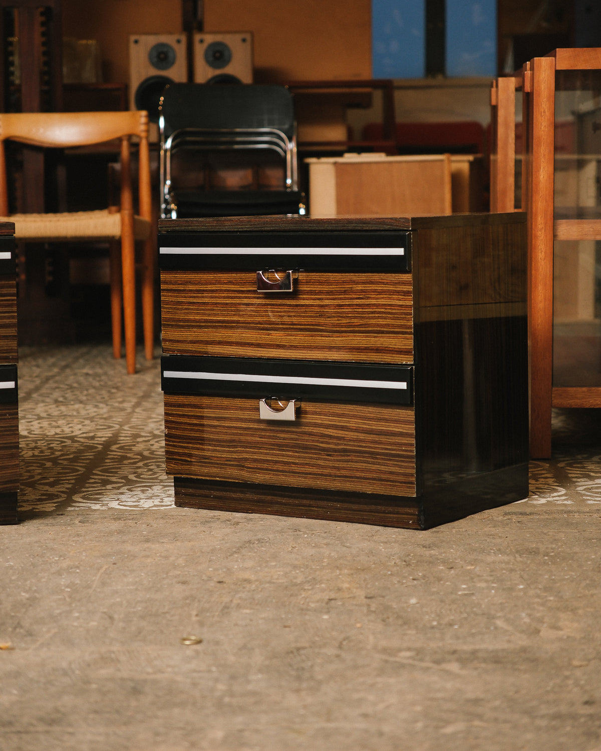 Full view of one nightstand in a showroom setting, showing overall proportions and finish.