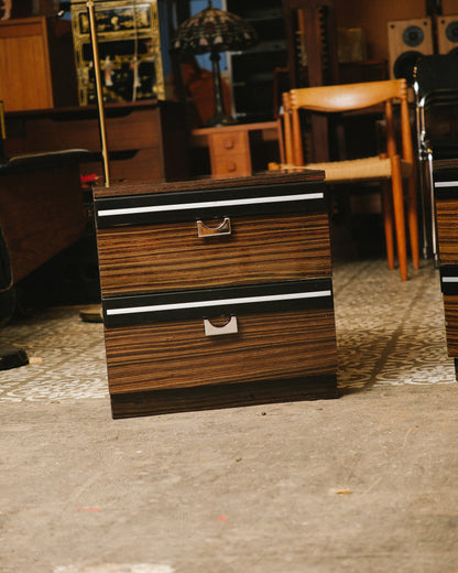 Front view of the second nightstand in the set, shown among other vintage furniture in the shop.
