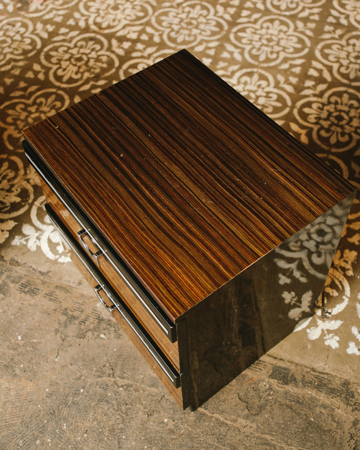 Side view showing the depth and glossy zebrawood side panel of the nightstand.
